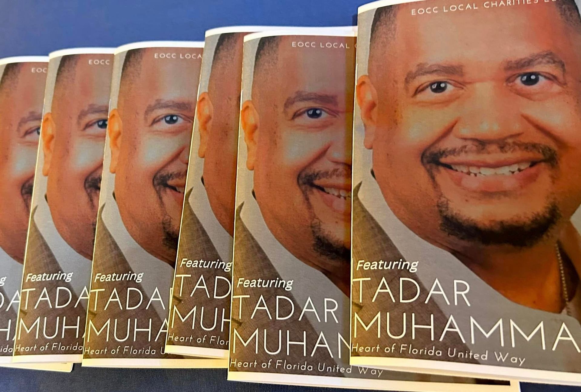 Books featuring a smiling man, 