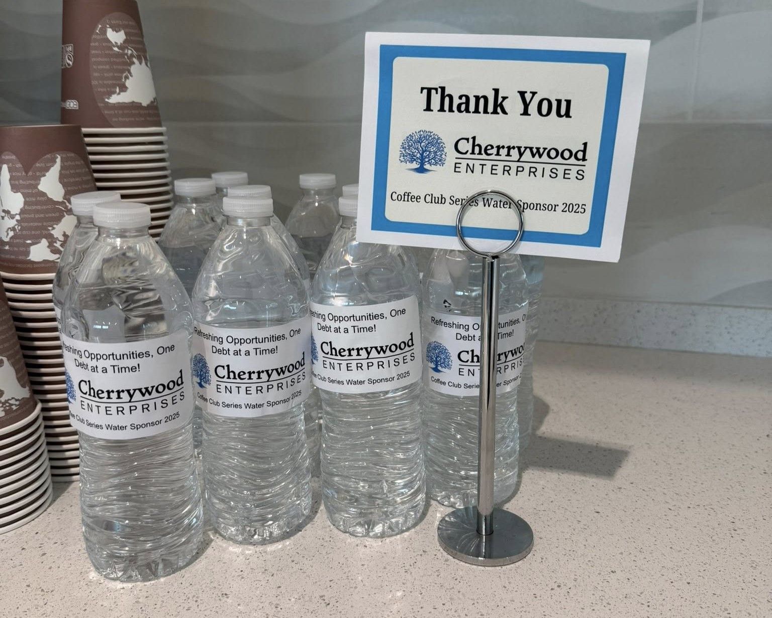 Bottled water with Cherrywood Enterprises labels next to a