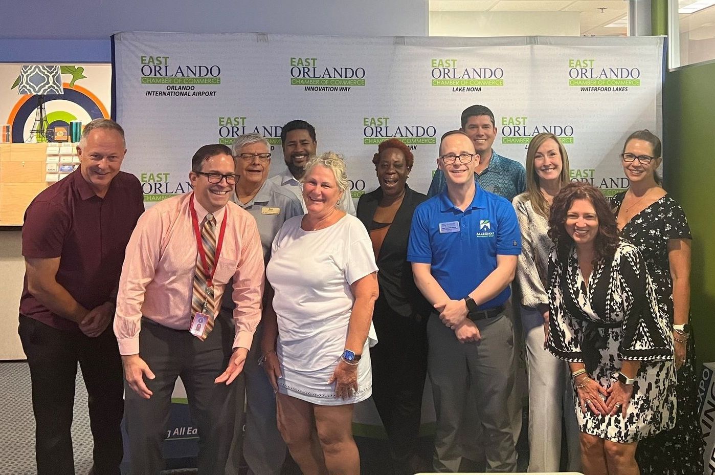 Group of people posing in front of a banner that says 