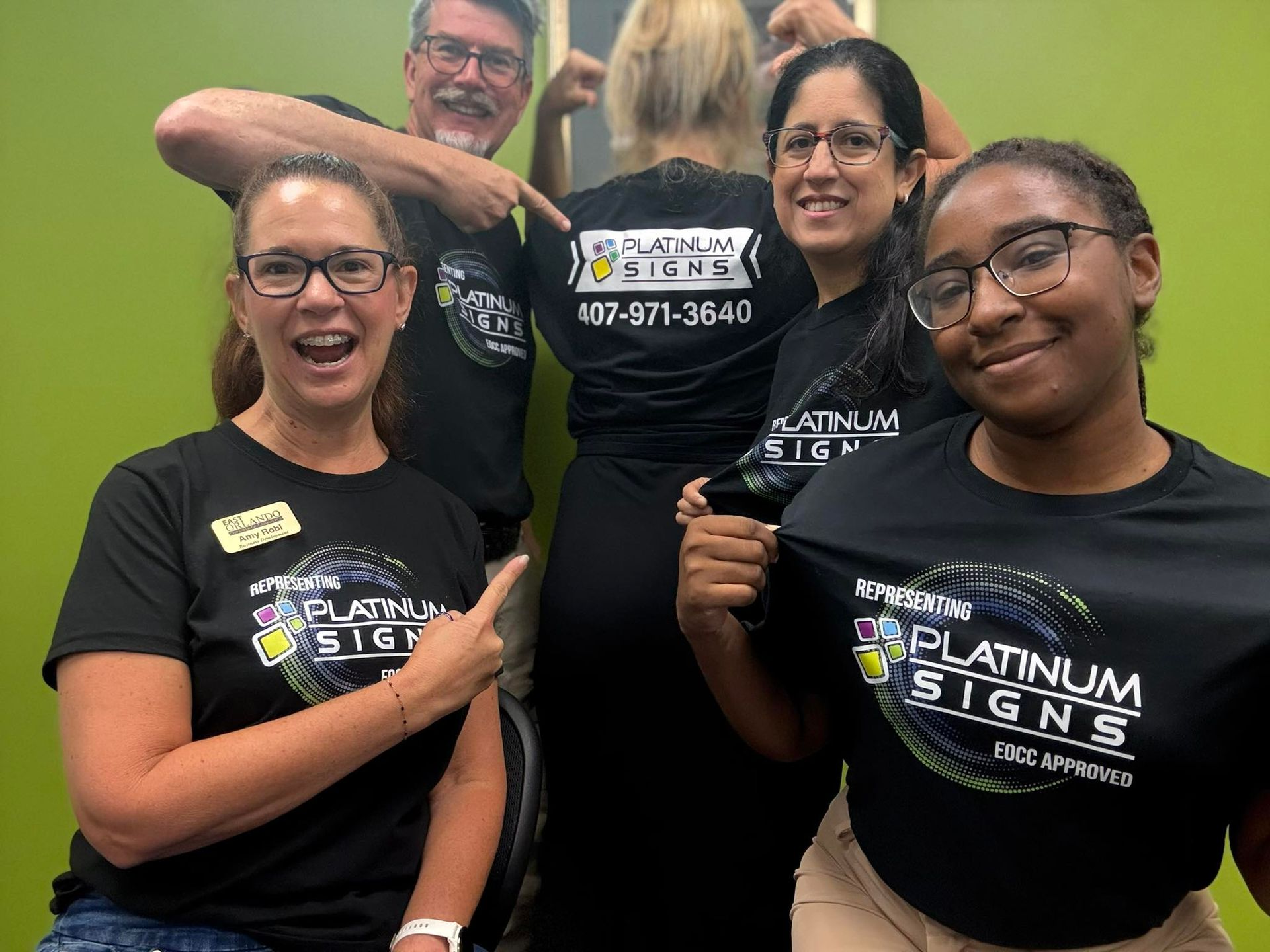 Five people in black t-shirts with