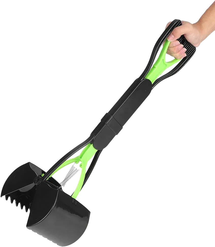 A person's hand holding a green and black dog poop scooper, ready to pick up waste.