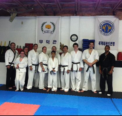 A group of martial arts fighters pose for a picture