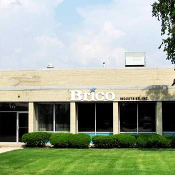 A large brick building with a sign that says brico on it.