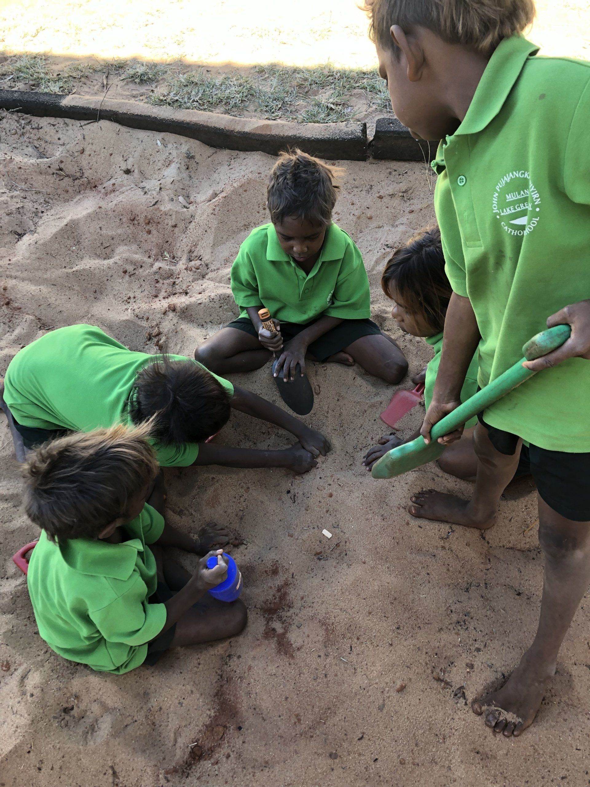 JPP Mulan students digging in sandpit