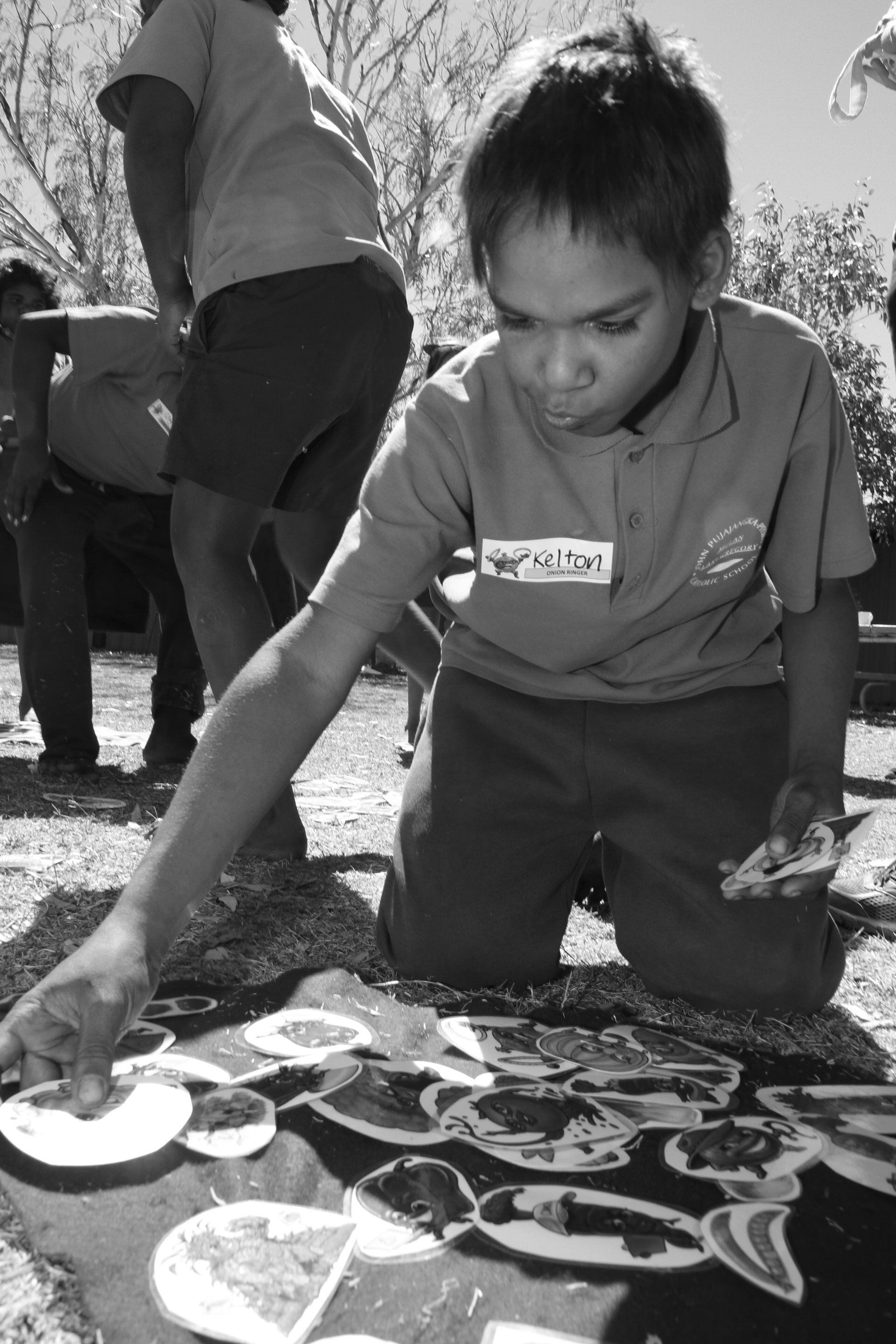 JPP School student on knees working on an outdoor project