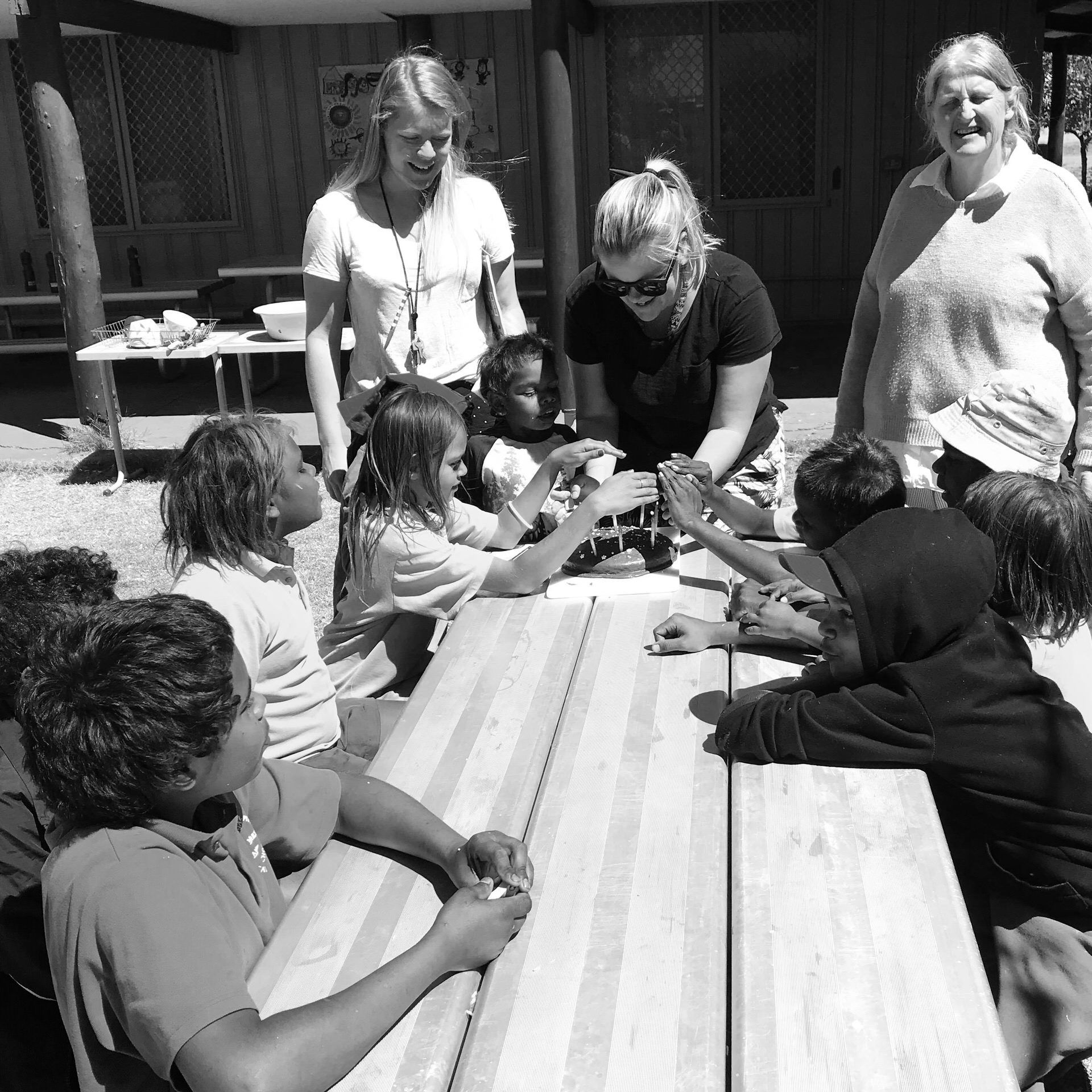 JPP School students and a teaching on an outdoor table
