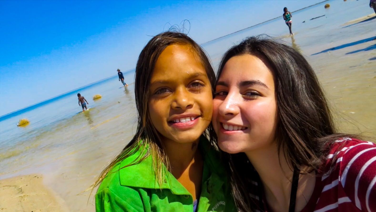 Student and teacher taking selfie at JPP school beach