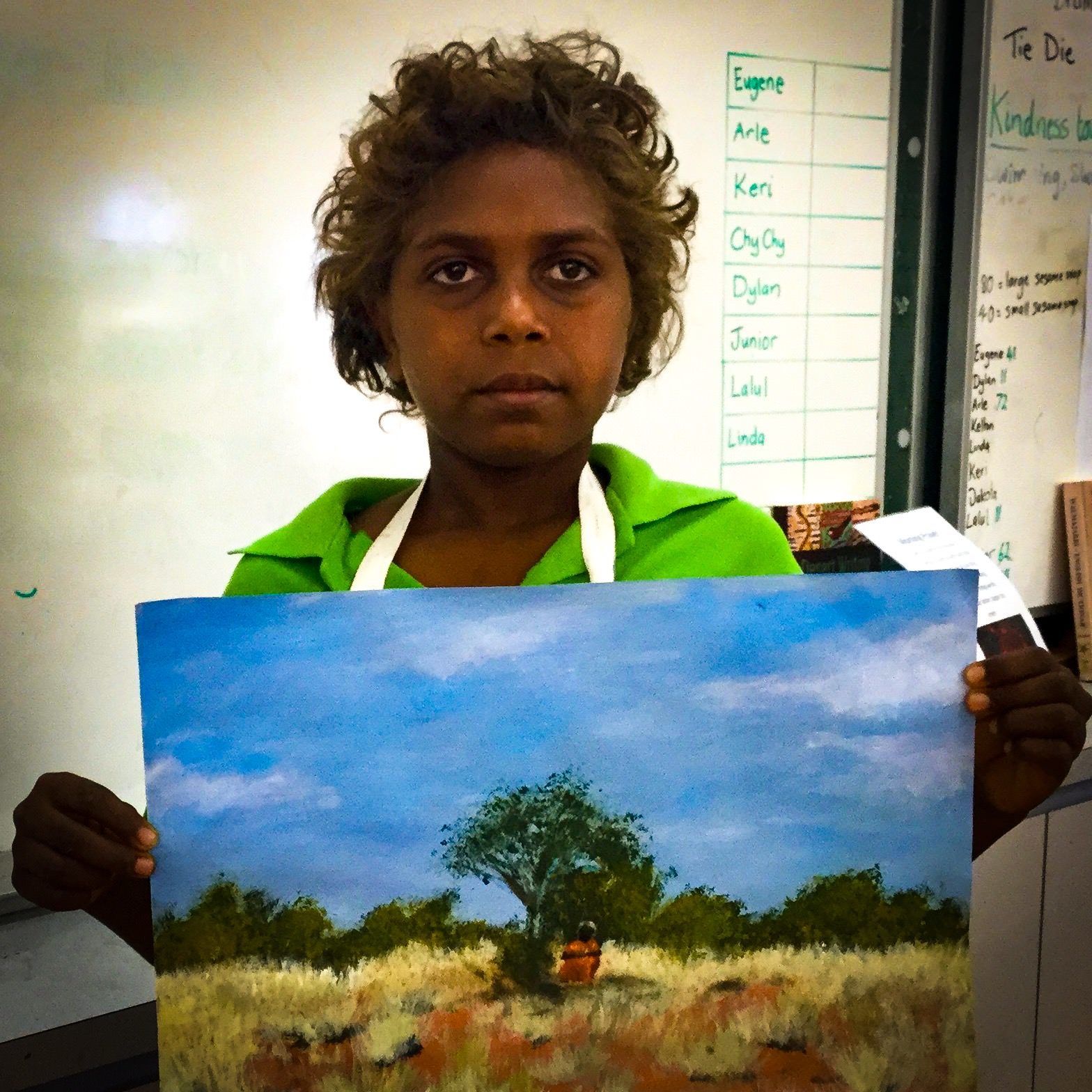 Jpp student holding a painting of a boab tree