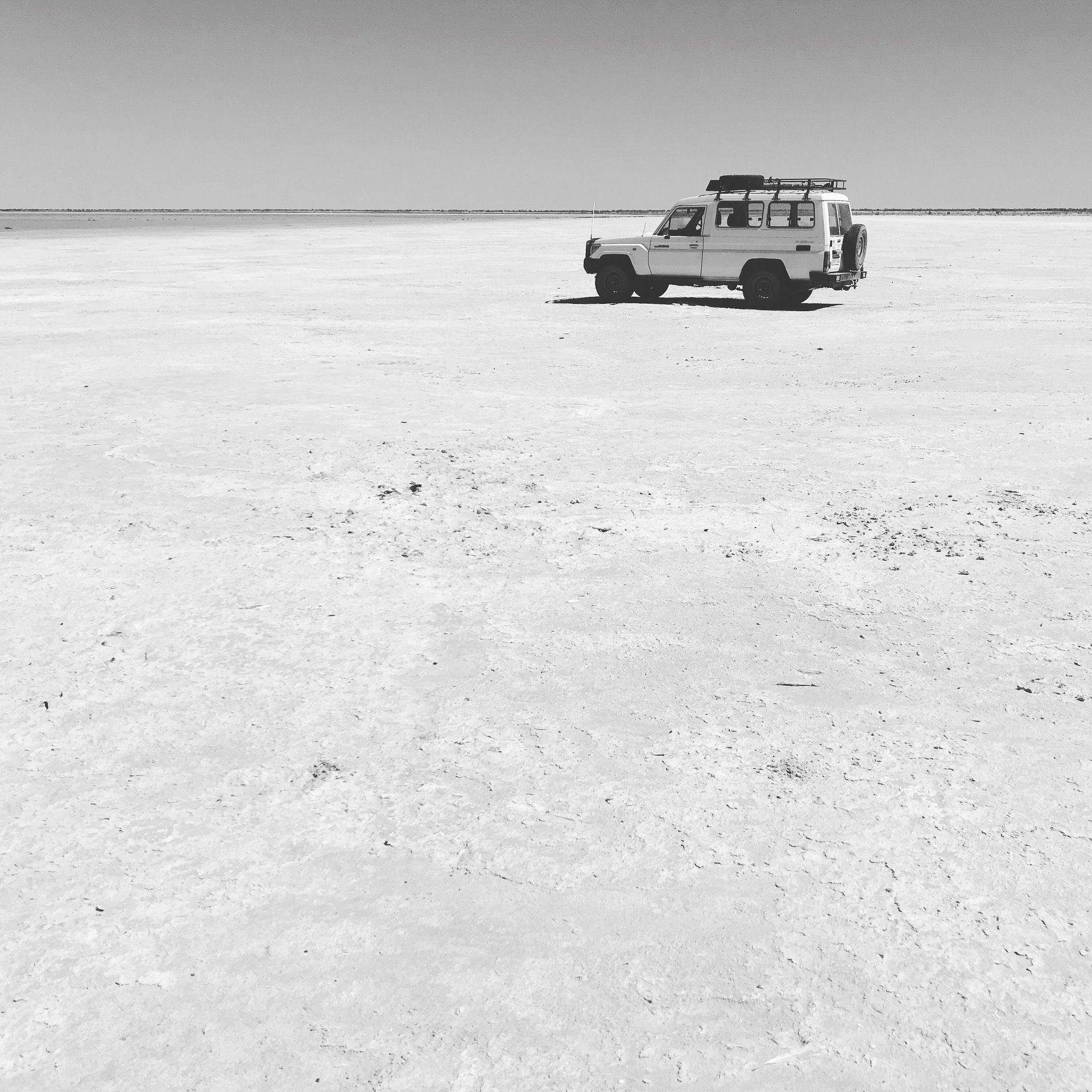 white toyota land cruiser on salt plain