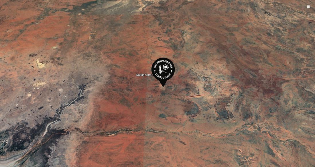 very wide drone view of JJP school