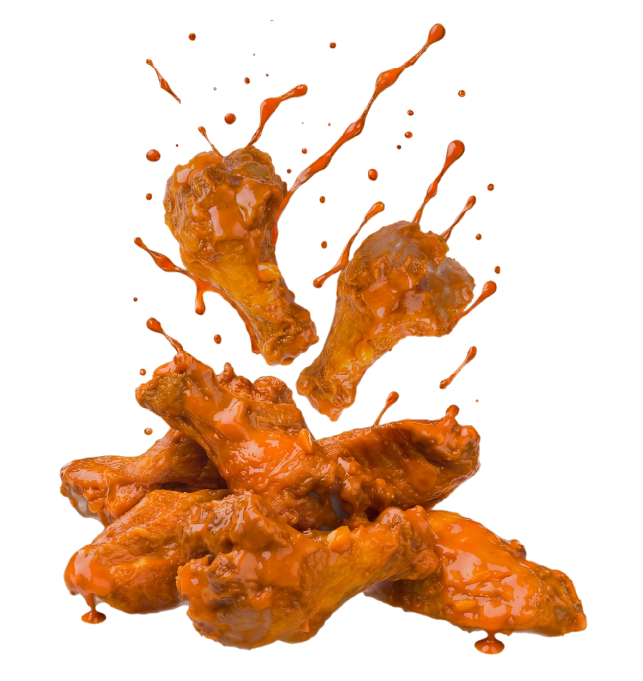 A pile of chicken wings with sauce splashing on them