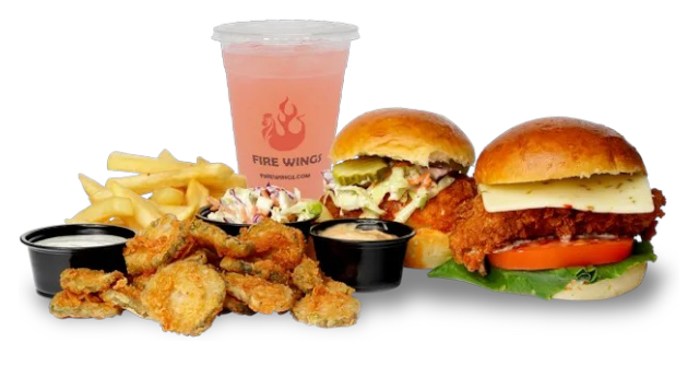 A hamburger , chicken nuggets , french fries and a drink are on a table.