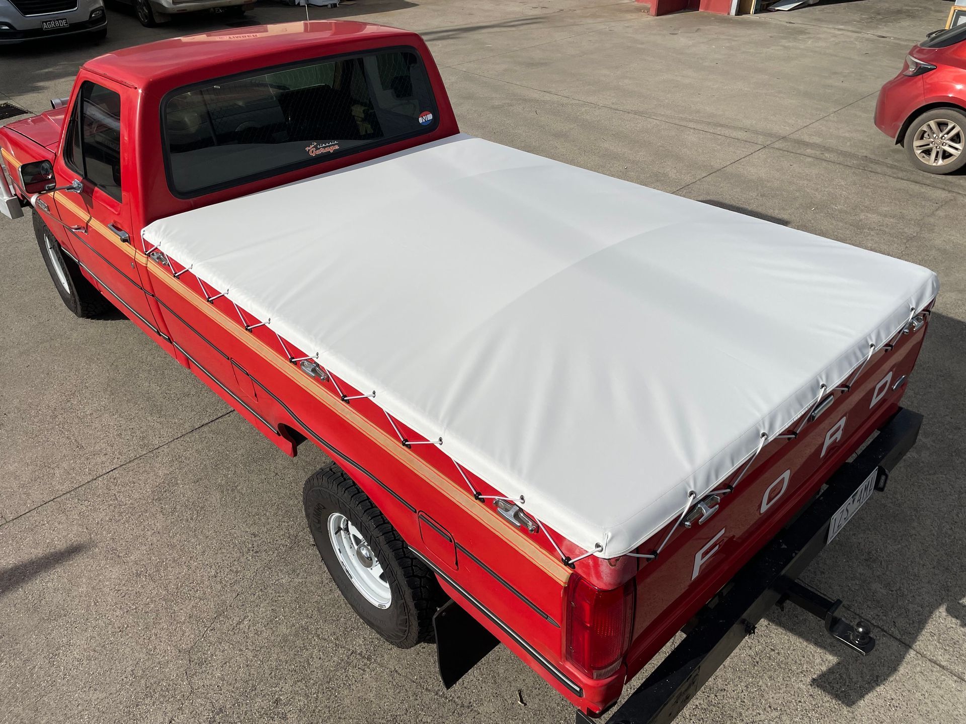 Ford F100 white tonneau cover with elastic rope