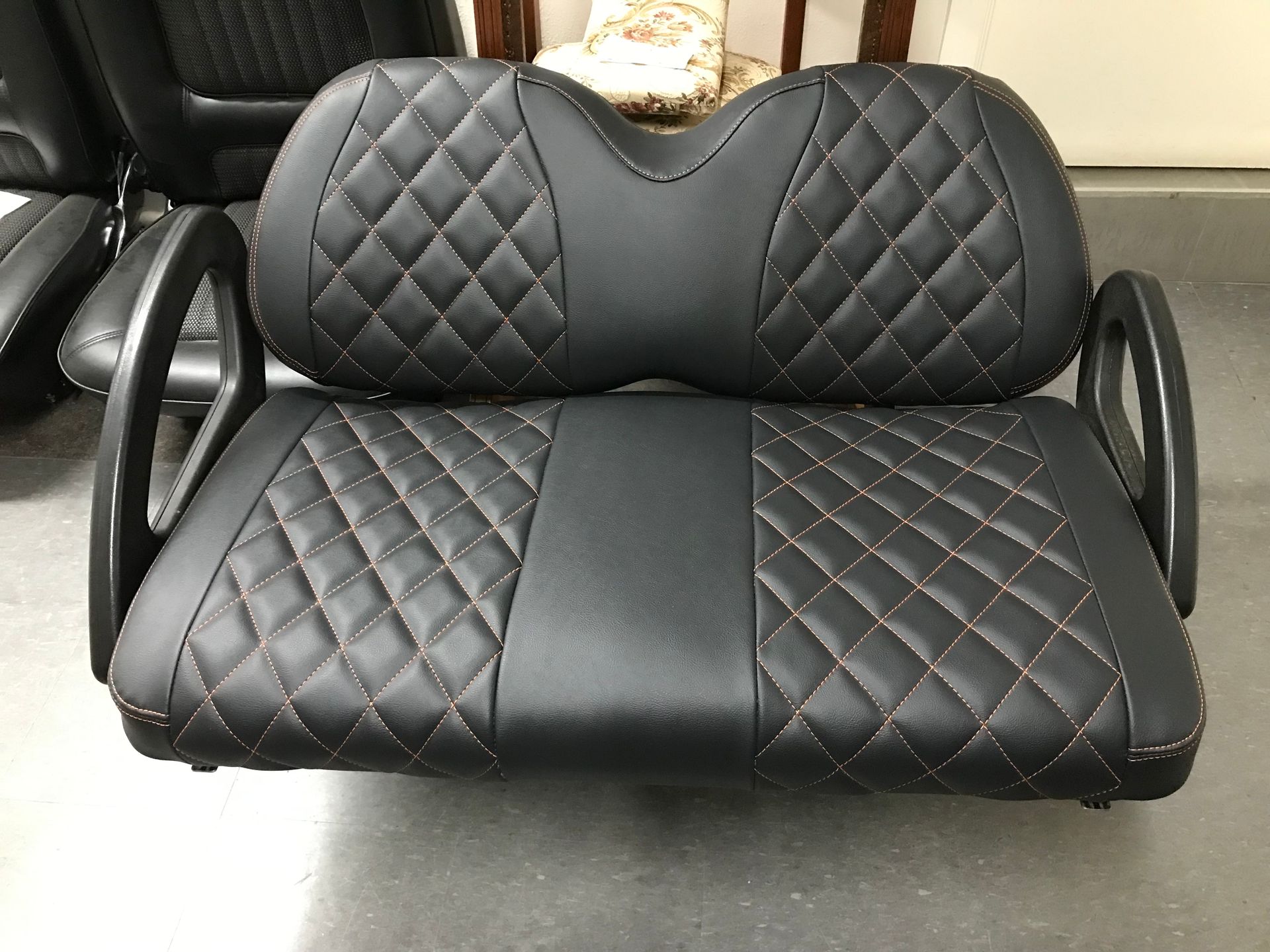 Golf cart black custom seat with cross stitch inserts