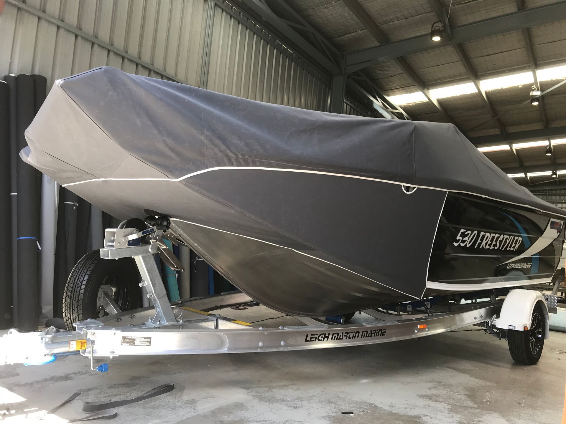 Quintrex 530 Freestyler grey canvas boat cover and stone shields