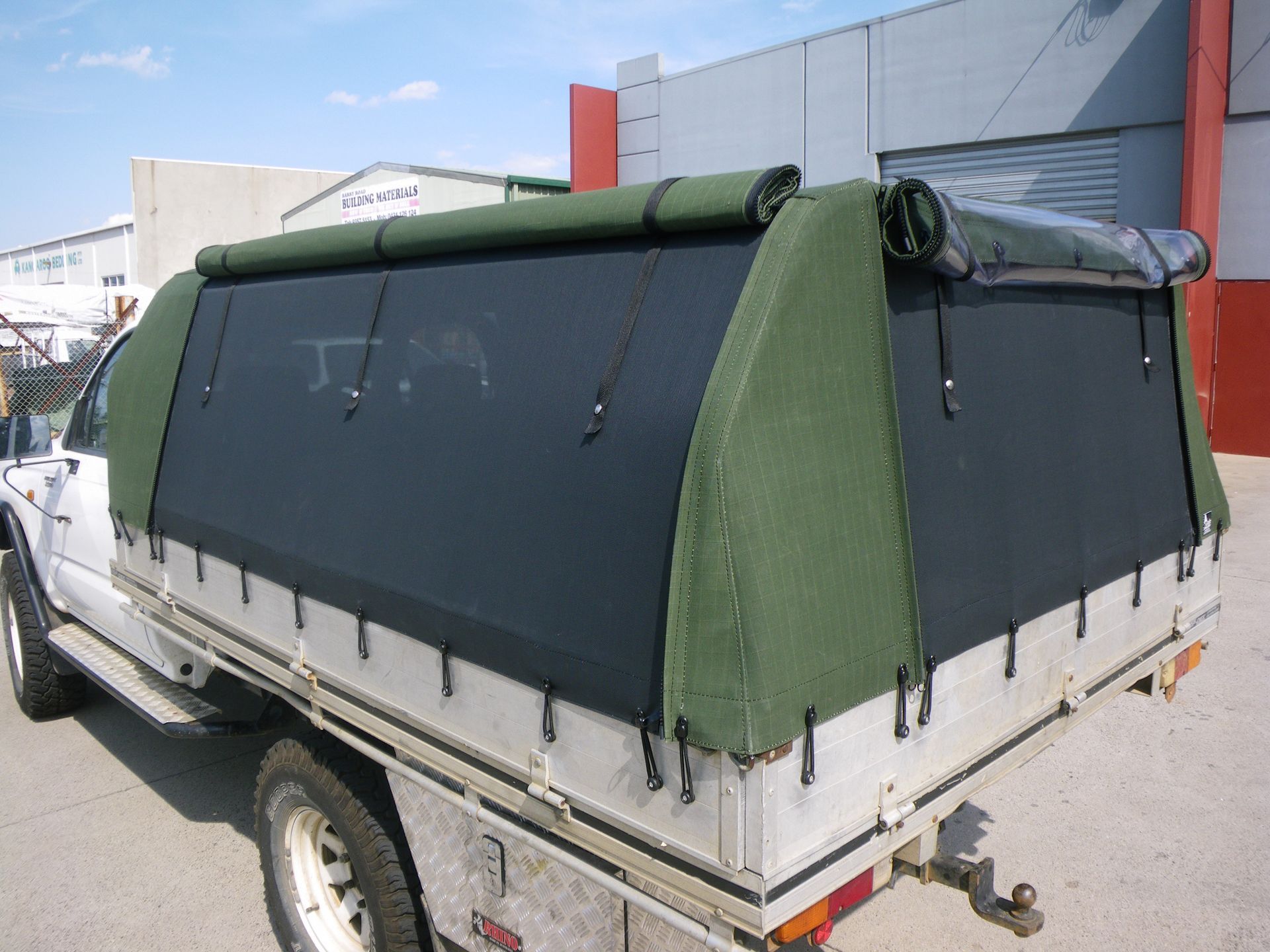Ute canopy with roll up sides and fly wire