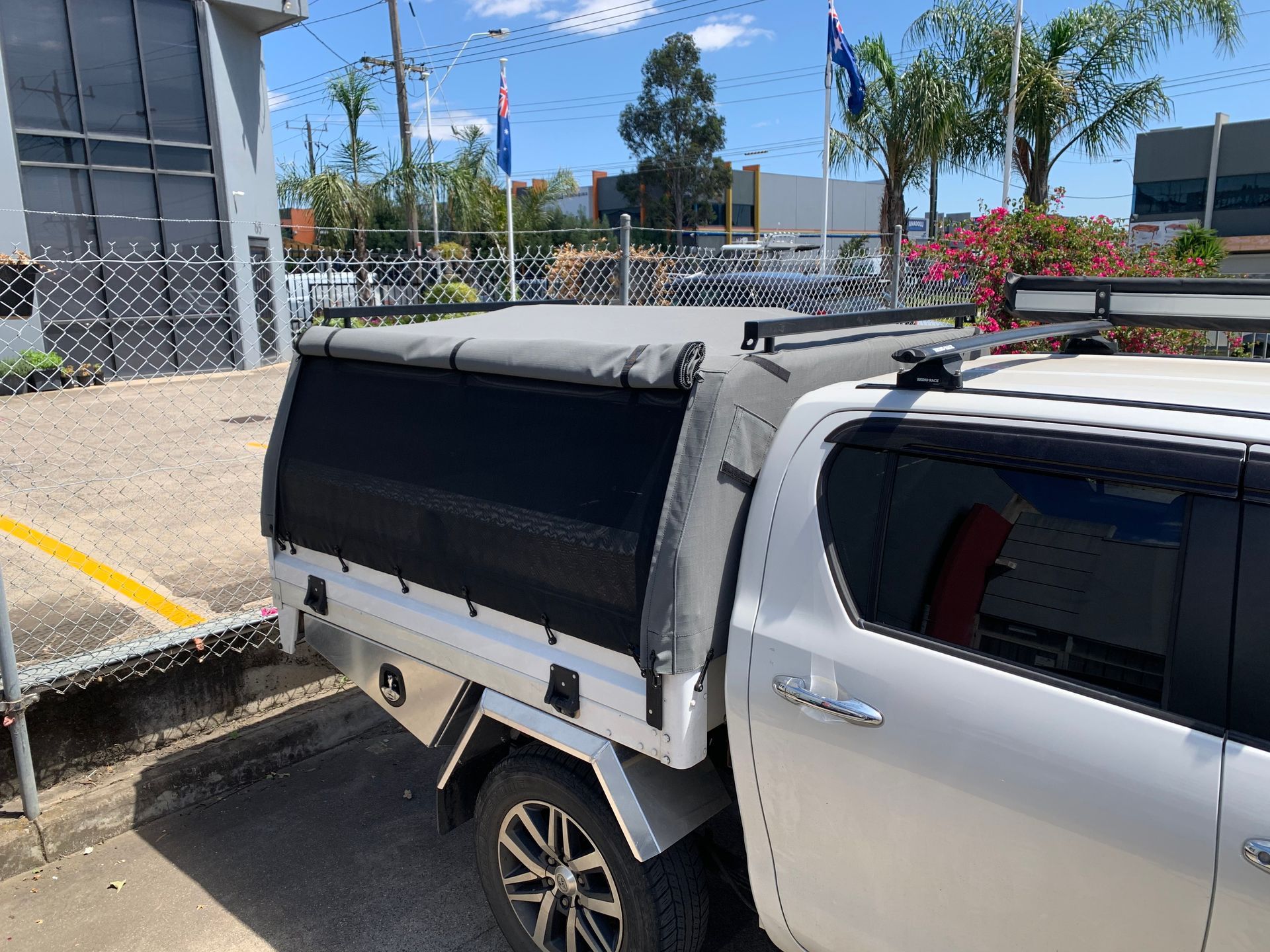 Ute canopy with mesh sides and boat carry bars