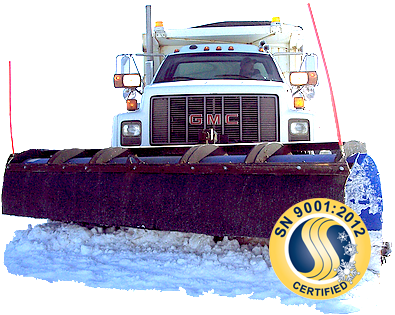 Snowplow truck plowing snow, front view. GMC truck with a black plow, blue and white snow, and a quality certification emblem.