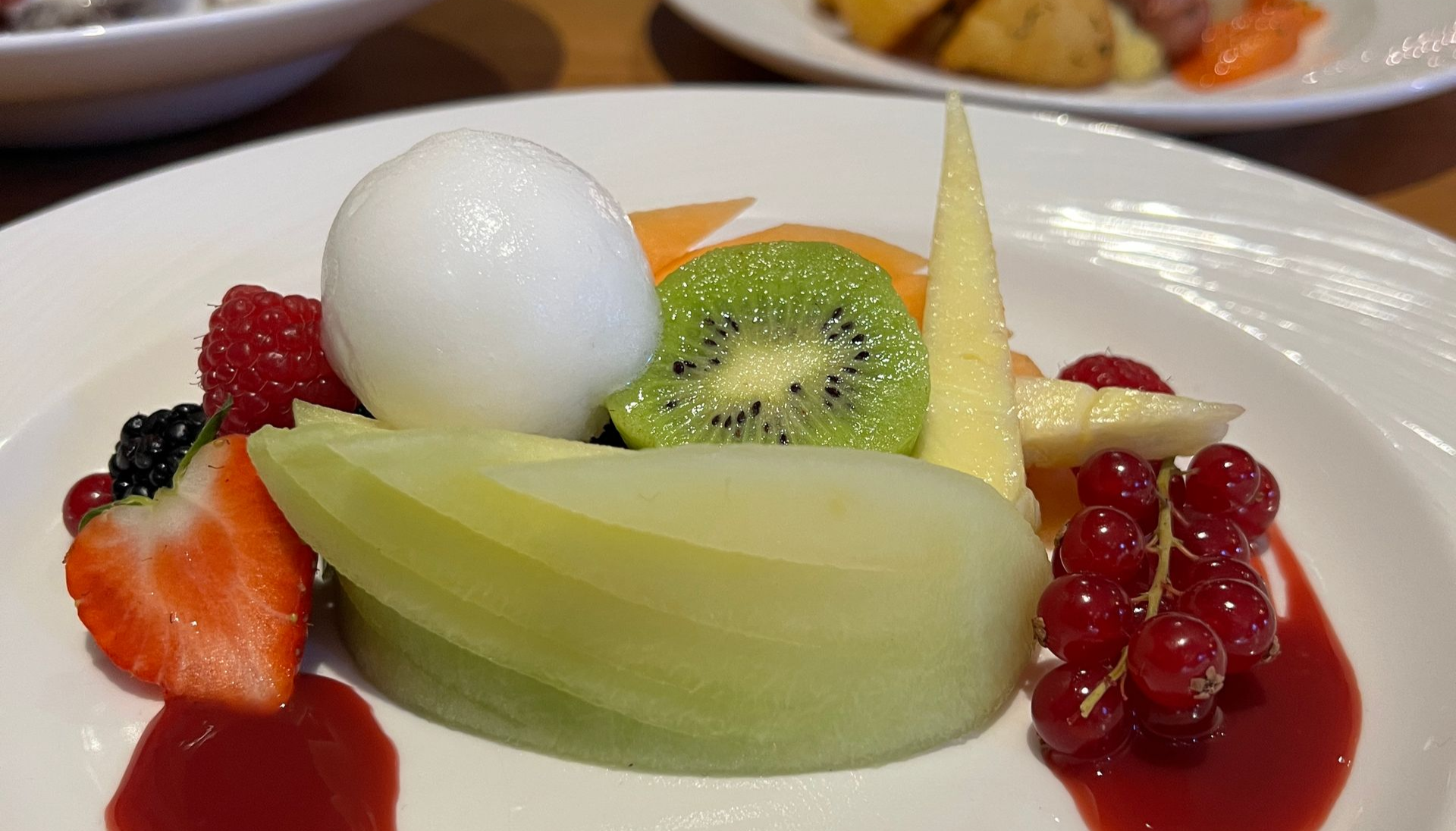 a close up of a plate of food with chicken spare ribs and sauce on a table .