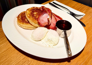 a close up of a sandwich with avocado and a poached egg on a plate .