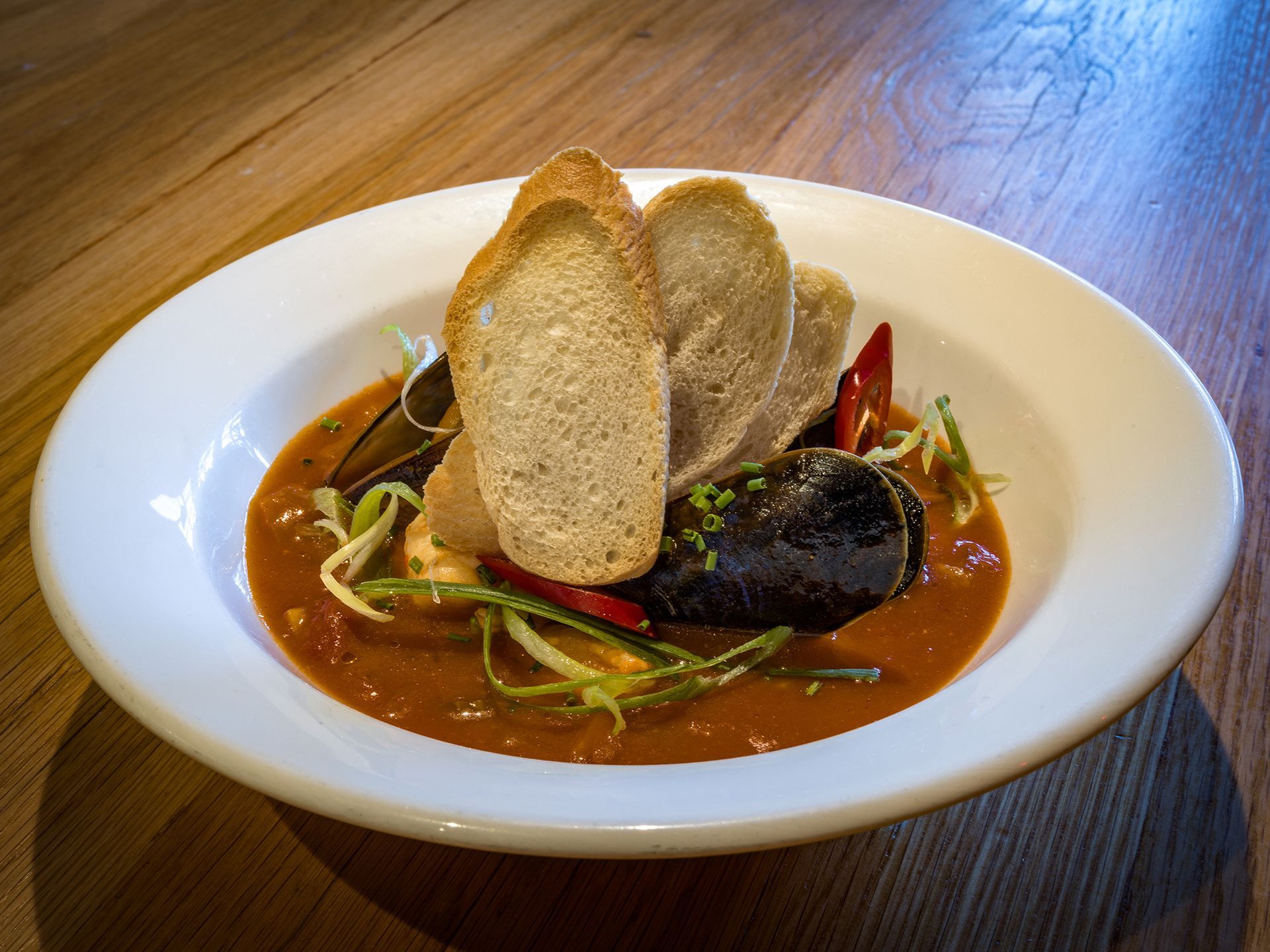 a bowl of soup with bread on top of it