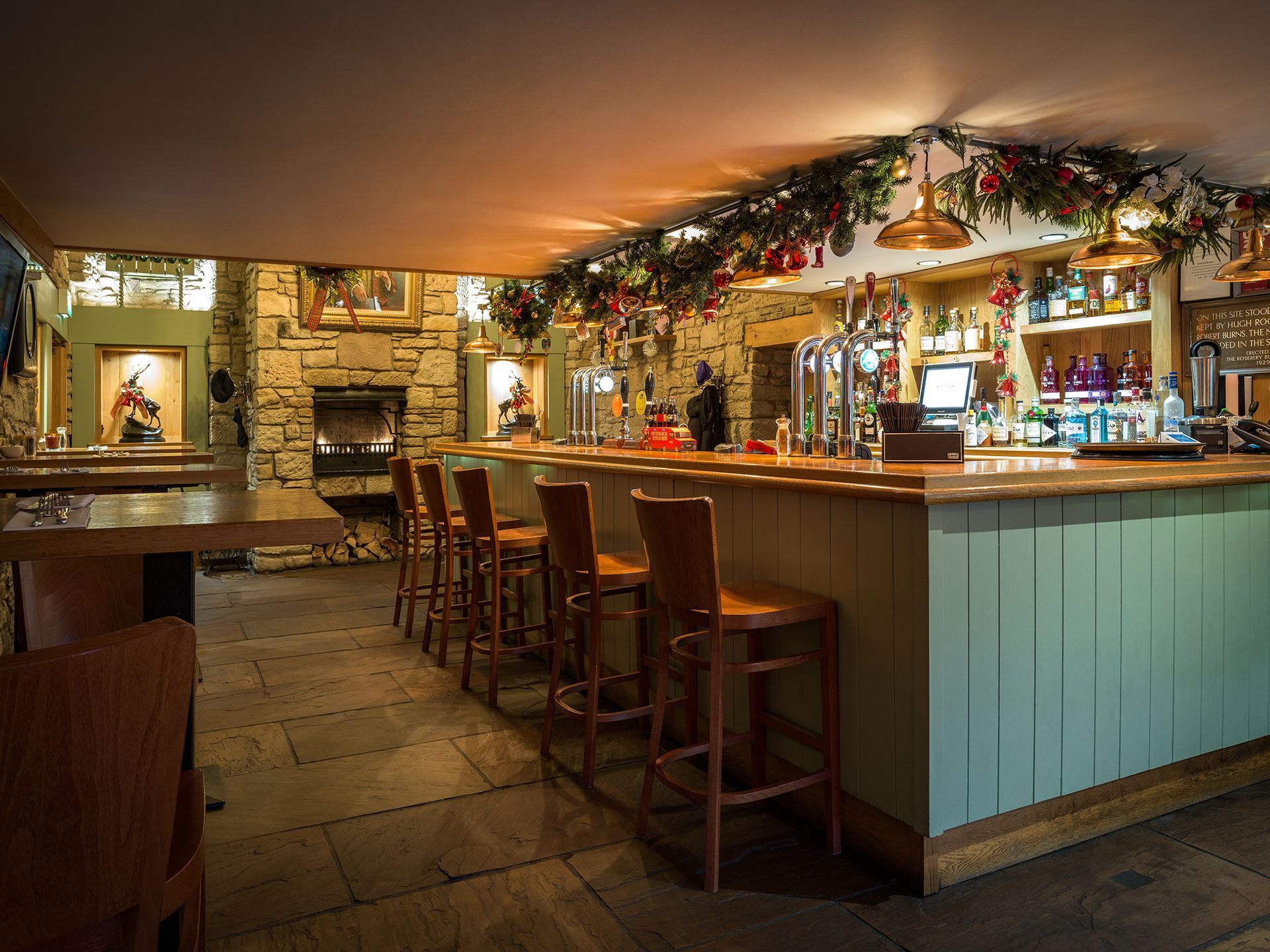 a bar in a restaurant with christmas decorations 