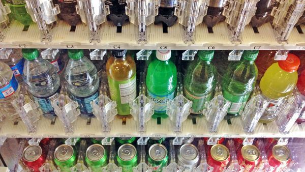 A vending machine filled with bottles of soda and water.
