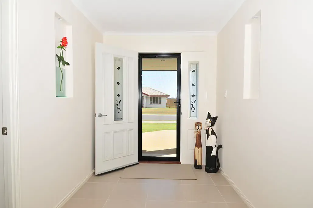 A Brightly Lit Home Entryway With Light Tile Floors — Advantage Screen And Blinds Rockhampton in Rockhampton, QLD