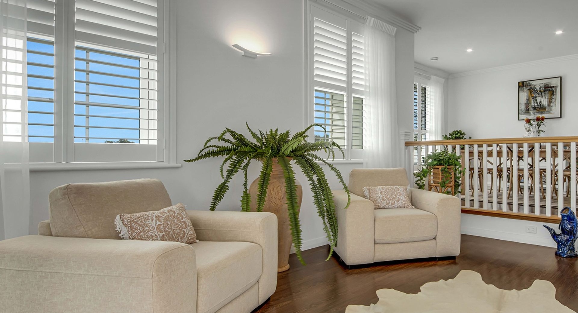 A Bright, Modern Living Room Featuring Cream-colored Armchairs — Advantage Screen And Blinds Rockhampton in Yeppoon, QLD