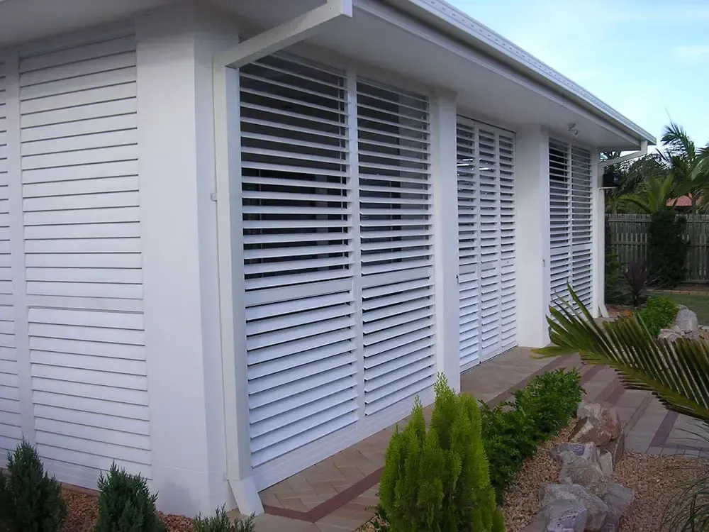 House Exterior Featuring Large Horizontal Louvered Shutters on Windows — Advantage Screen And Blinds Rockhampton in Rockhampton, QLD