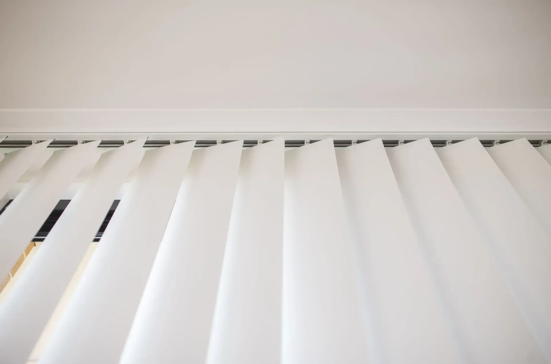 A Low-angle View of White Vertical Window Blinds — Advantage Screen And Blinds Rockhampton in Rockhampton, QLD