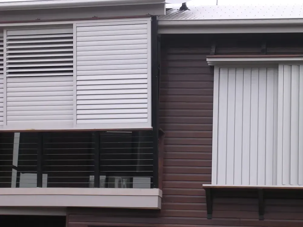 A House Exterior With Louvered Sliding Shutters and Vertical Blinds — Advantage Screen And Blinds Rockhampton in Rockhampton, QLD