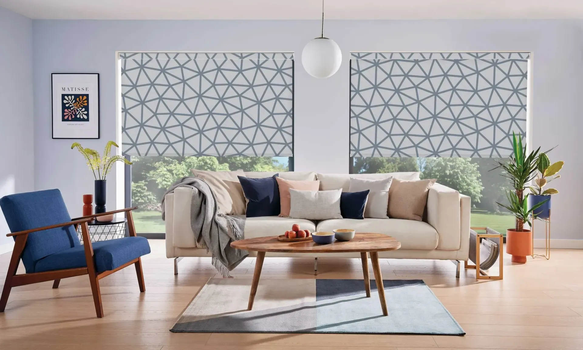 A Living Room With a Cream Armchair and Windows — Advantage Screen And Blinds Rockhampton in Rockhampton, QLD