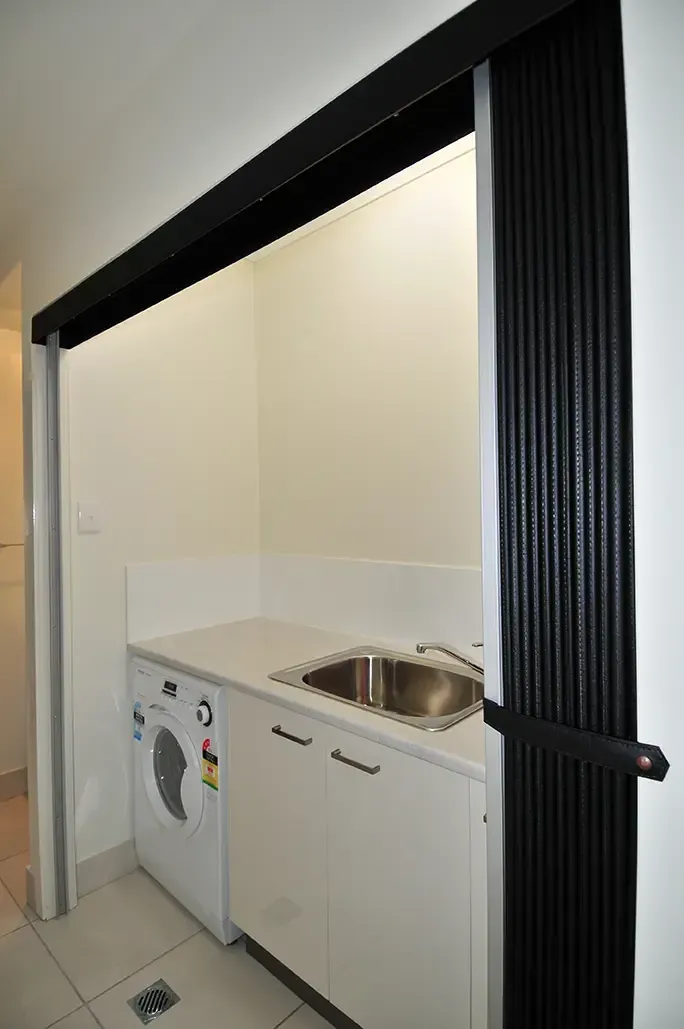Laundry Nook Featuring a Washing Machine and Sink — Advantage Screen And Blinds Rockhampton in Rockhampton, QLD