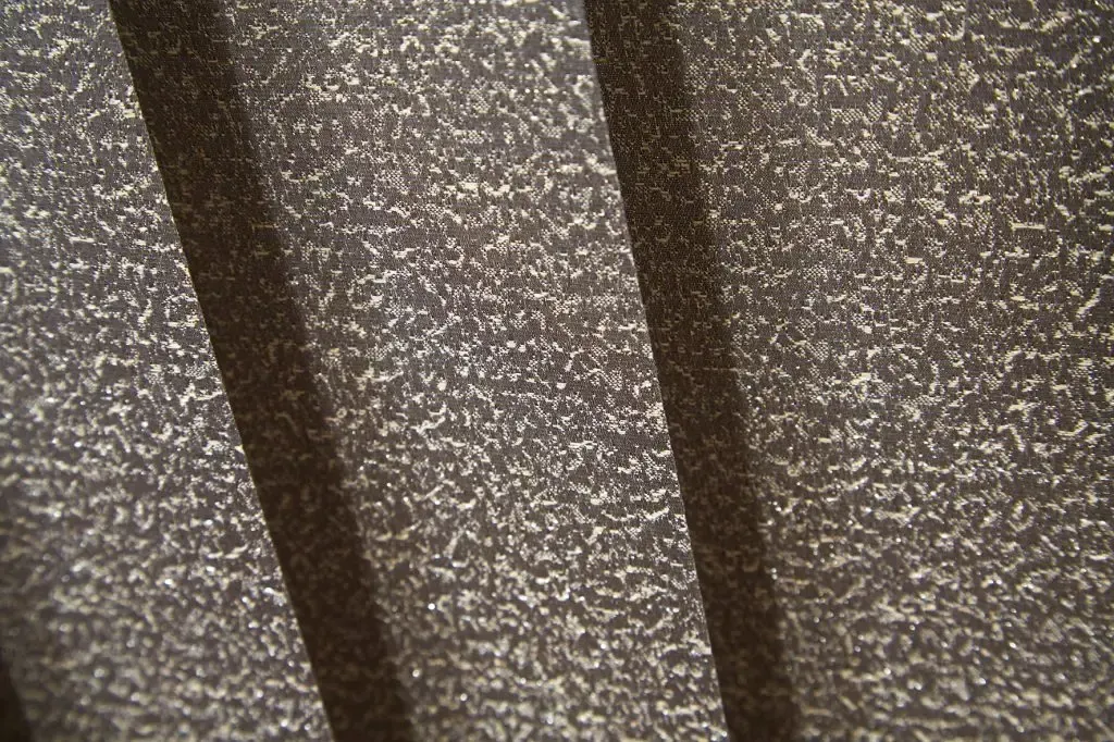 Metal Surface With a Textured, Speckled Finish and Two Diagonal Grooves — Advantage Screen And Blinds Rockhampton in Rockhampton, QLD