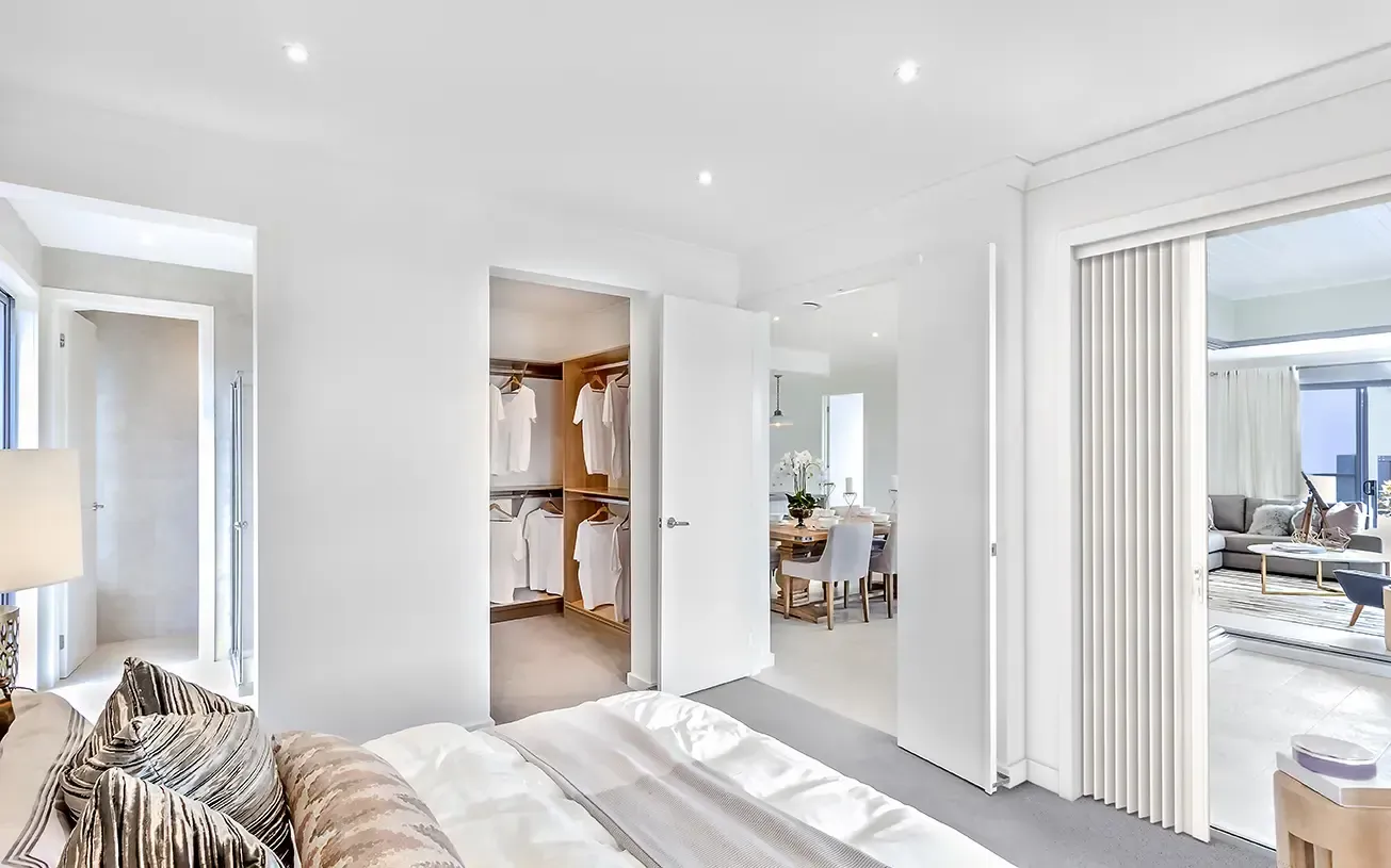 Bedroom Features a Walk-in Closet, a Sliding Door, and a Bed With Neutral Bedding — Advantage Screen And Blinds Rockhampton in Rockhampton, QLD