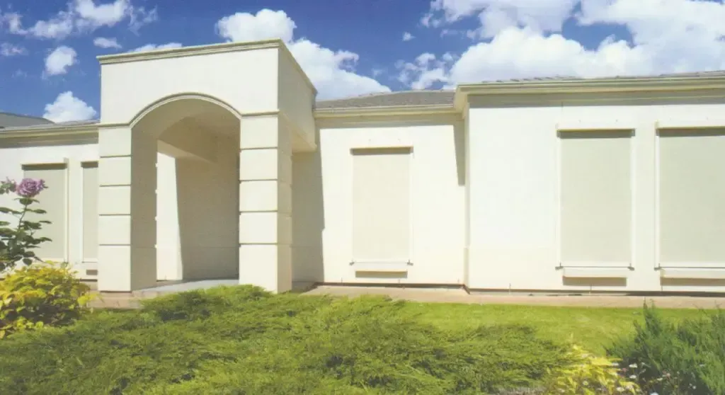 House Exterior With an Arched Entryway and Closed Roll-down Shutters on the Windows — Advantage Screen And Blinds Rockhampton in Rockhampton, QLD