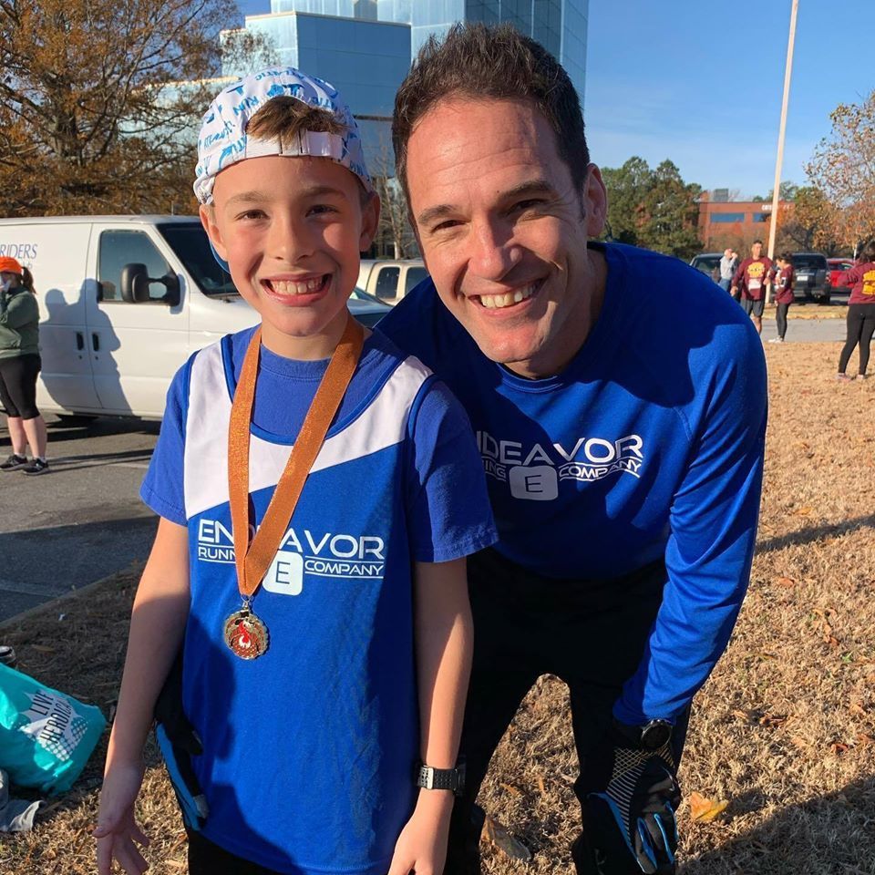 A man and a boy wearing blue shirts with the word favor on them