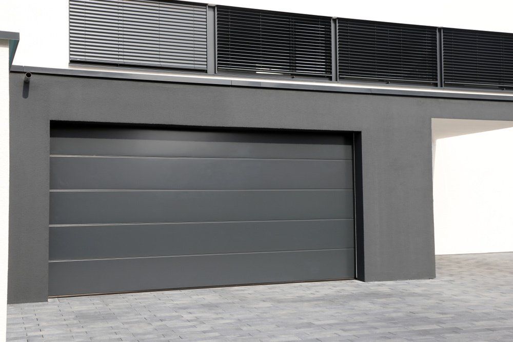 A Black Modern Sectional Garage Door — Darwin Roller Door Services In Tivendale NT