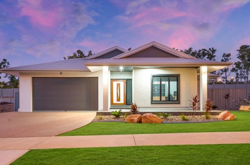 A Large House with A Lush Green Lawn in Front of It — Darwin Roller Door Services In Tivendale NT
