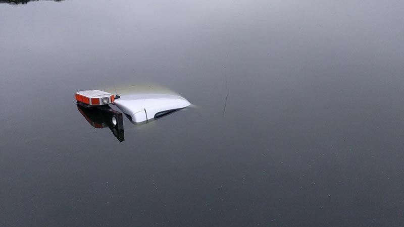 A boat is floating on top of a body of water.