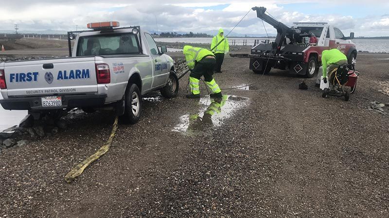 A first alarm truck is being towed by a tow truck.