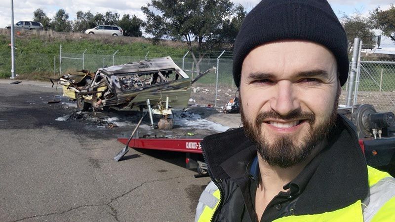 A man standing in a lost car.