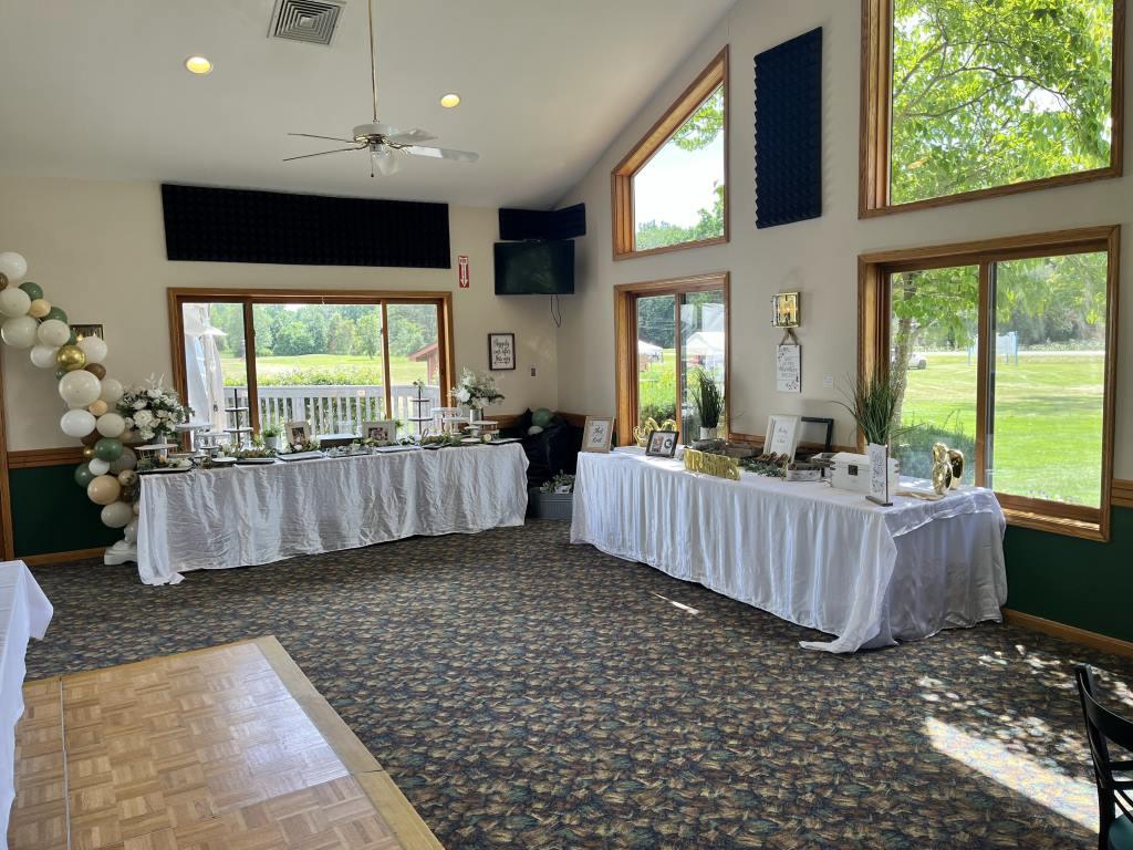 A large room with tables and a dance floor