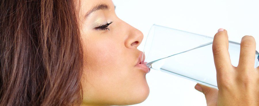 woman drinking a glass of water