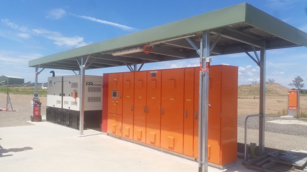 A row of orange lockers under a green roof.