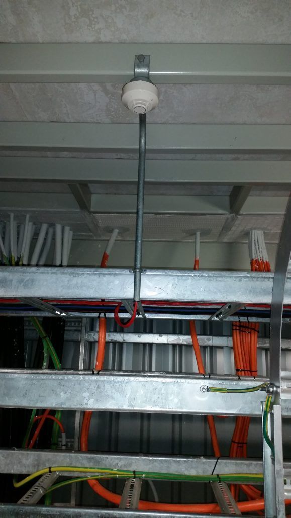 A ceiling with a bunch of wires hanging from it