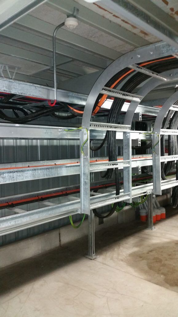 A bunch of wires are hanging from the ceiling of a building.