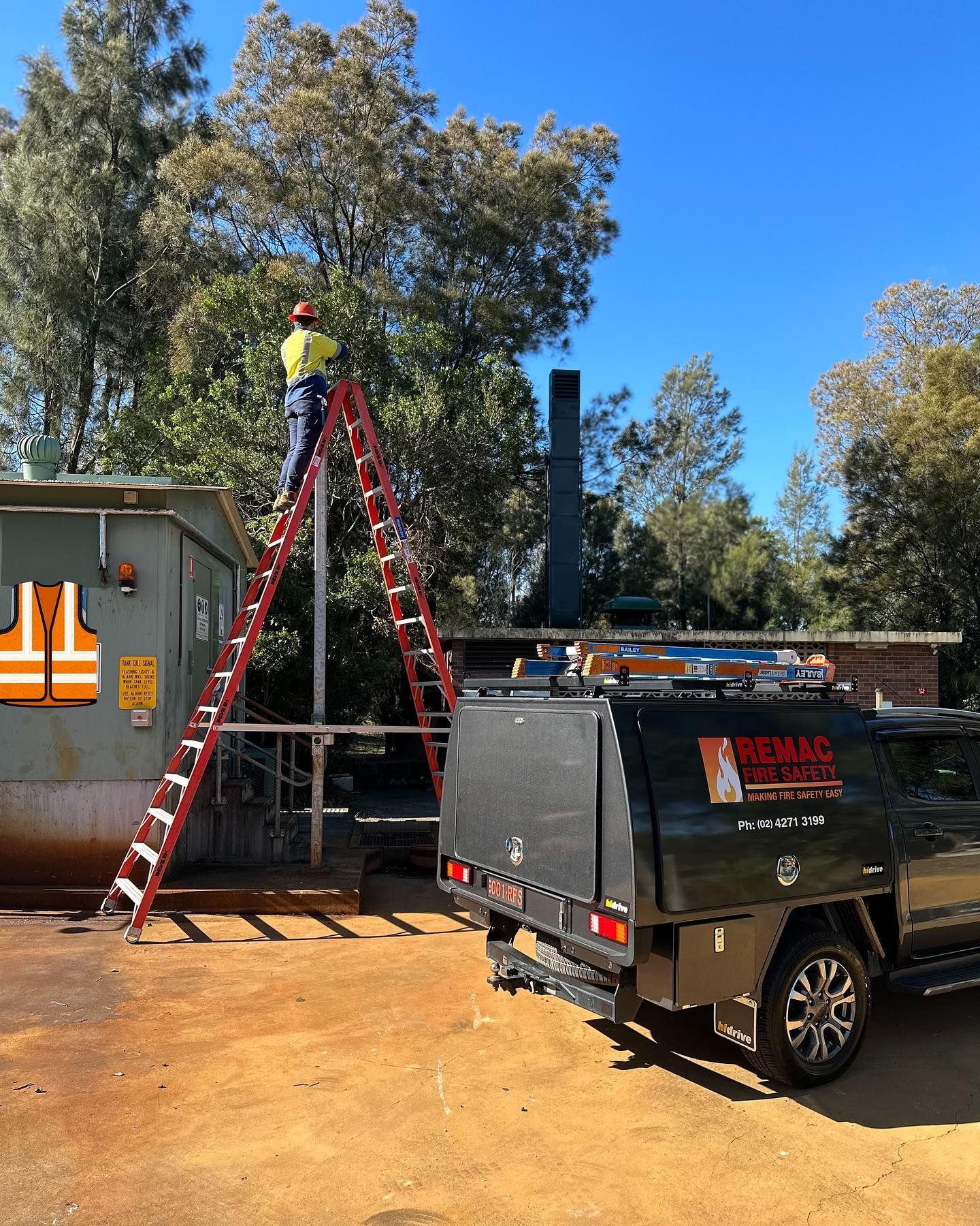 A man is standing on a ladder next to a truck.