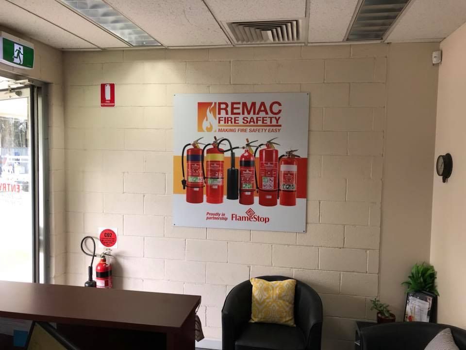 A room with a sign on the wall that says remac fire safety.